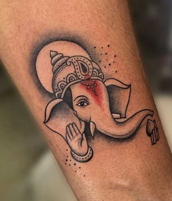This Ganesh tattoo shows the god with only two arms. | Ratta Tattoo